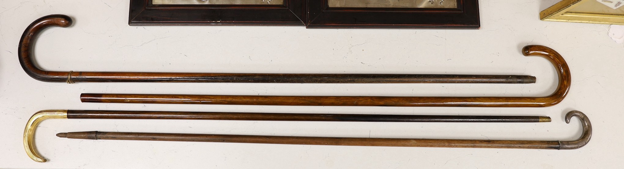 Four various walking sticks, one silver mounted and another gilt metal mounted and impressed ‘Antoine’